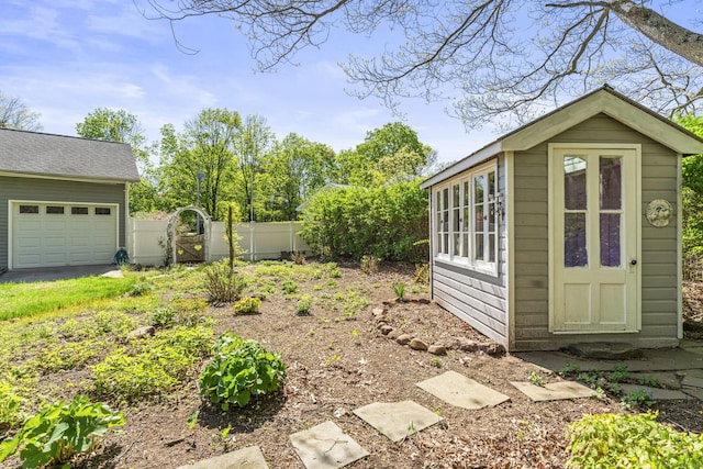 view of yard with a gate, fence, and an outdoor structure