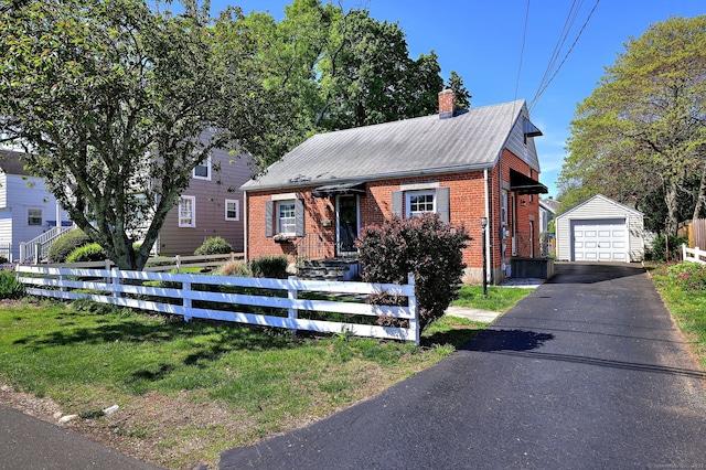 172 Alden St, Fairfield, CT 06824 - view of front of home featuring brick siding, a fenced front yard, an outbuilding, a garage, and a chimney