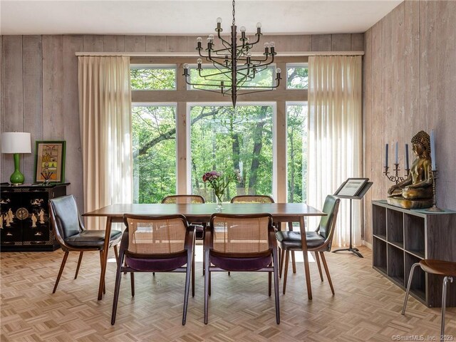 95 Shinar Mountain Rd, Washington, CT 06794 - dining space with an inviting chandelier, plenty of natural light, and wood walls