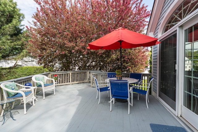 wooden terrace featuring outdoor dining area