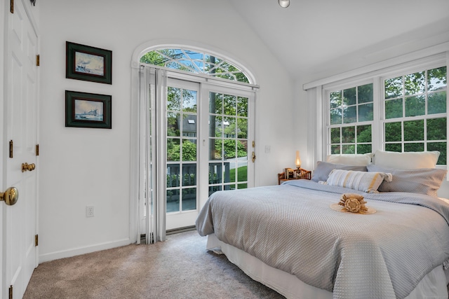 carpeted bedroom featuring access to exterior, baseboards, and high vaulted ceiling