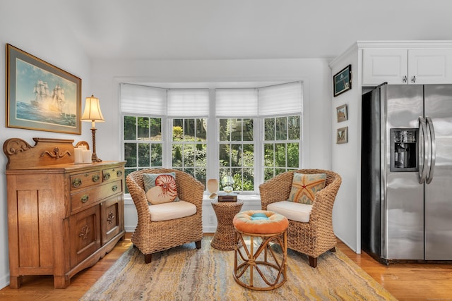 living area with healthy amount of natural light and light wood-type flooring