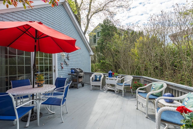 view of patio / terrace with a wooden deck, area for grilling, and outdoor dining area