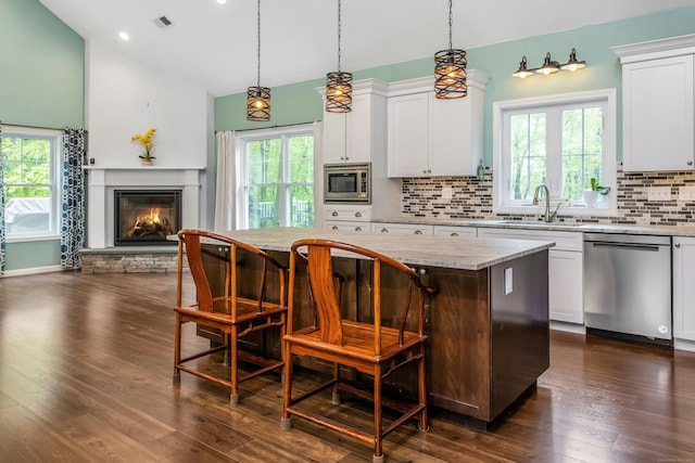 4 Aunt Park Ln, Newtown, CT 06470 - kitchen with appliances with stainless steel finishes, a sink, a kitchen island, backsplash, and healthy amount of natural light