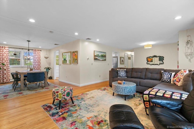 living room with baseboards, recessed lighting, visible vents, and wood finished floors