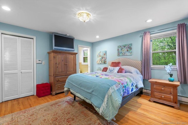 bedroom with recessed lighting, a closet, light wood-type flooring, and multiple windows