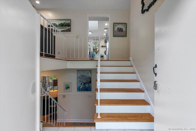 staircase with tile patterned flooring, baseboards, and recessed lighting