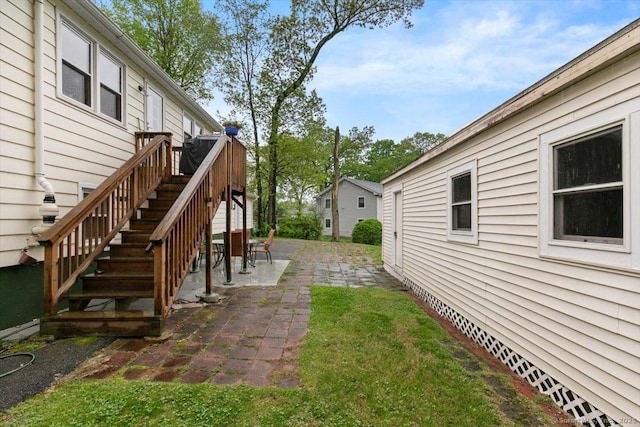 view of yard with stairs and a patio