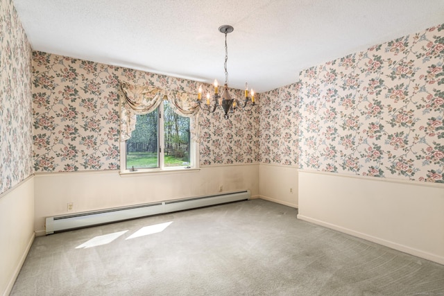 carpeted spare room with a baseboard heating unit, a chandelier, wallpapered walls, and a wainscoted wall