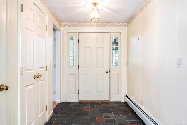 entryway with a baseboard radiator and dark stone finish flooring