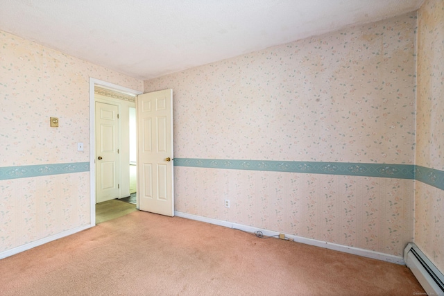 empty room featuring a baseboard radiator, light colored carpet, wallpapered walls, and baseboards