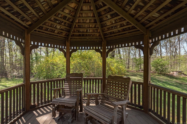 wooden terrace featuring a gazebo and a yard
