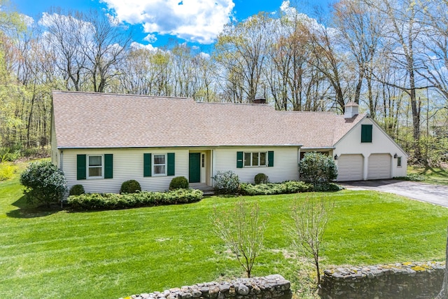 single story home with a chimney, a shingled roof, a front yard, and asphalt driveway