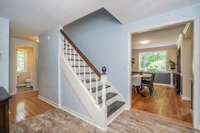 440 Huckleberry Hill Rd, Avon, CT 06001 - stairs with healthy amount of natural light, wood finished floors, and baseboards