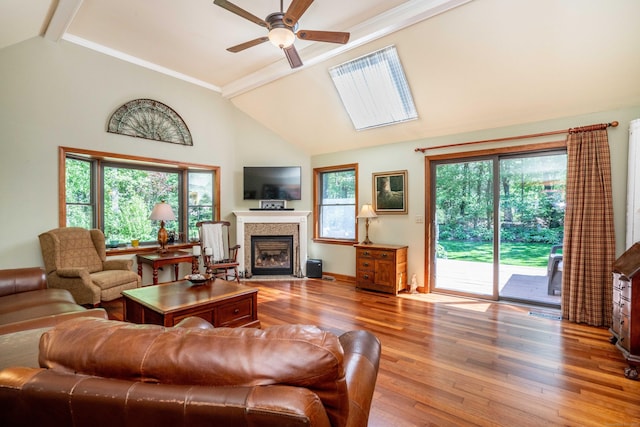 440 Huckleberry Hill Rd, Avon, CT 06001 - living area with a fireplace with flush hearth, a ceiling fan, wood finished floors, beamed ceiling, and high vaulted ceiling