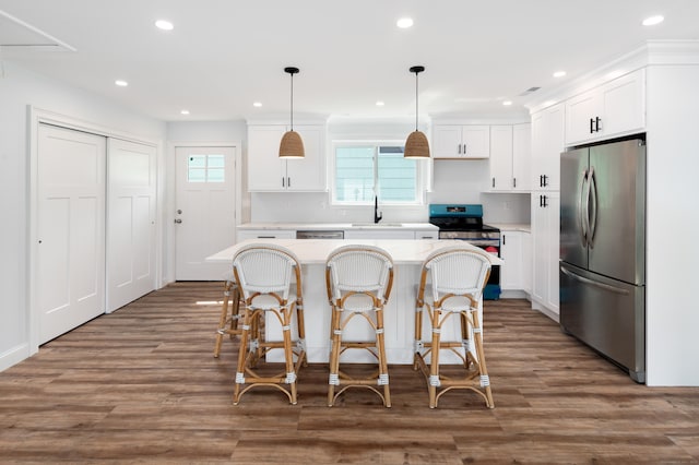 24 Sea Crest Ave, East Lyme, CT 06357 - kitchen with stainless steel appliances, a sink, a center island, white cabinetry, and light countertops