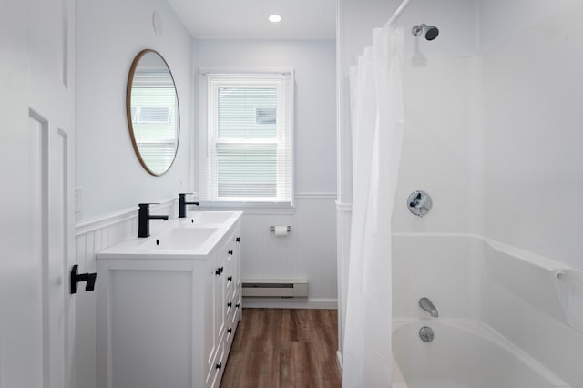 24 Sea Crest Ave, East Lyme, CT 06357 - bathroom featuring wainscoting, a baseboard heating unit, wood finished floors, vanity, and shower / tub combo