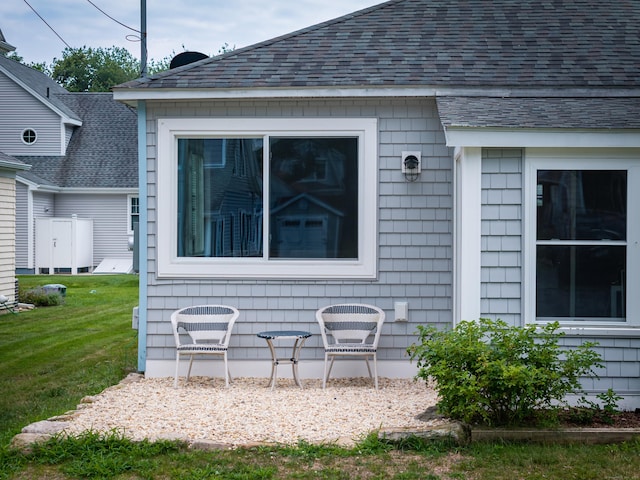 24 Sea Crest Ave, East Lyme, CT 06357 - doorway to property featuring a yard and roof with shingles