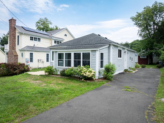 24 Sea Crest Ave, East Lyme, CT 06357 - view of front of home featuring a front yard, a chimney, and a shingled roof