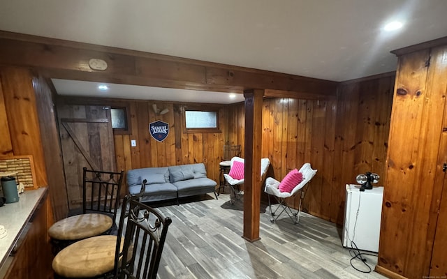 living area featuring wood finished floors and wooden walls