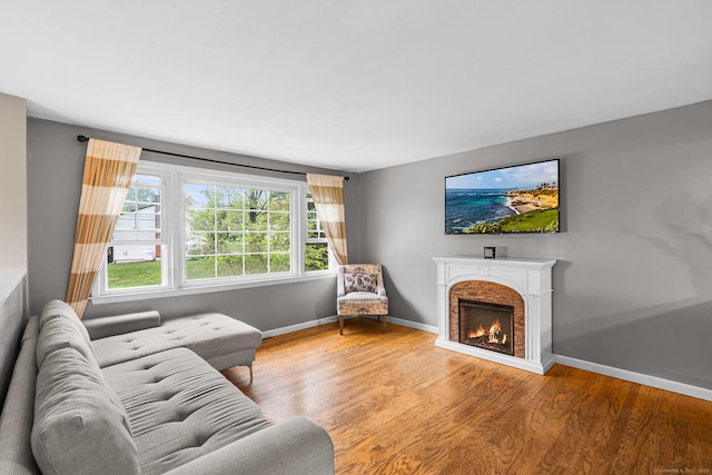 1 Glen Cir, Seymour, CT 06483 - living area featuring wood finished floors, a lit fireplace, and baseboards