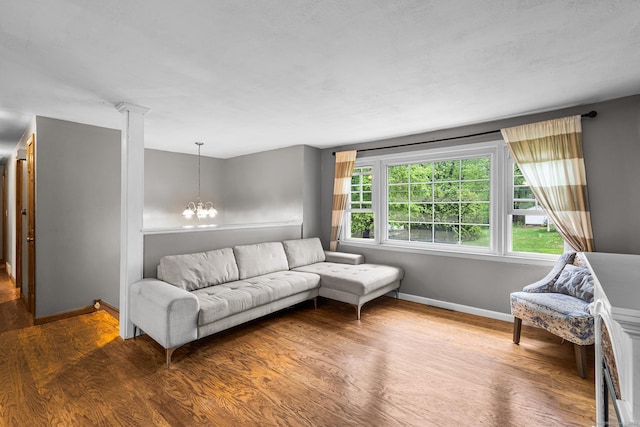1 Glen Cir, Seymour, CT 06483 - living room with a chandelier, baseboards, and wood finished floors