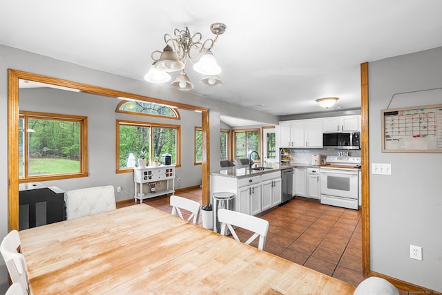 1 Glen Cir, Seymour, CT 06483 - kitchen featuring appliances with stainless steel finishes, a sink, white cabinets, a chandelier, and tasteful backsplash