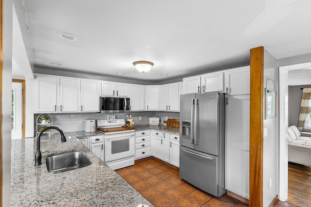 1 Glen Cir, Seymour, CT 06483 - kitchen featuring appliances with stainless steel finishes, a sink, light stone counters, and white cabinetry