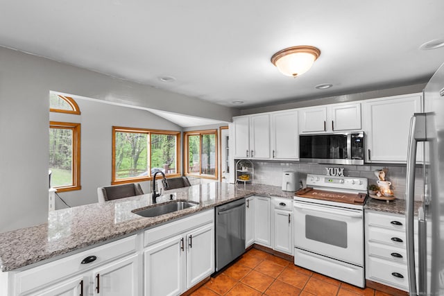 1 Glen Cir, Seymour, CT 06483 - kitchen featuring appliances with stainless steel finishes, a sink, lofted ceiling, tasteful backsplash, and a peninsula