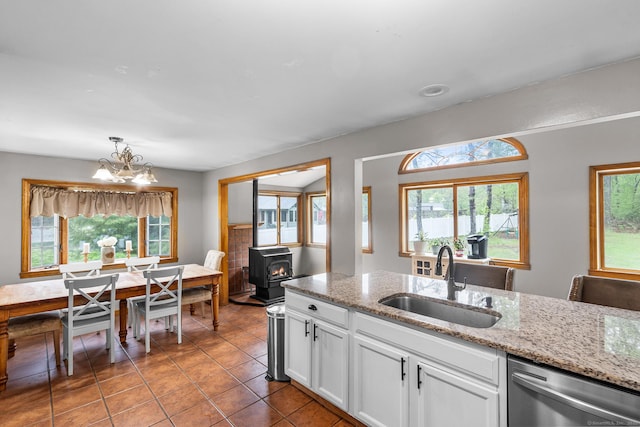 1 Glen Cir, Seymour, CT 06483 - kitchen with a sink, stainless steel dishwasher, a chandelier, white cabinetry, and tile patterned floors