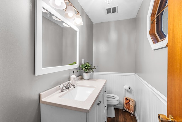 1 Glen Cir, Seymour, CT 06483 - half bath featuring wainscoting, toilet, wood finished floors, and vanity