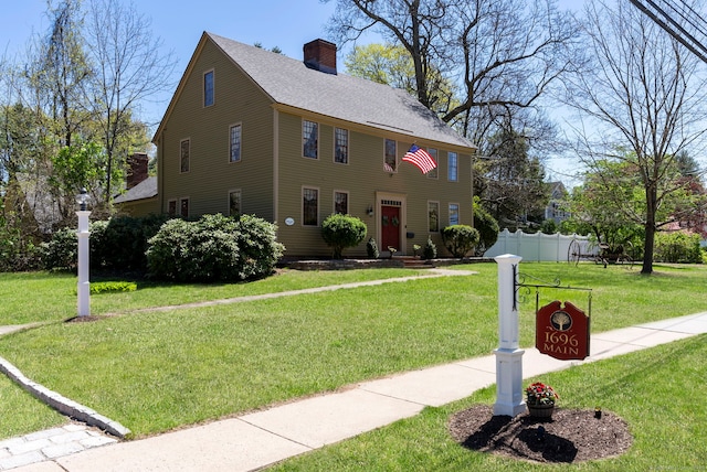 1696 Main St, Glastonbury, CT 06033 - colonial inspired home featuring a chimney, a front yard, roof with shingles, and fence
