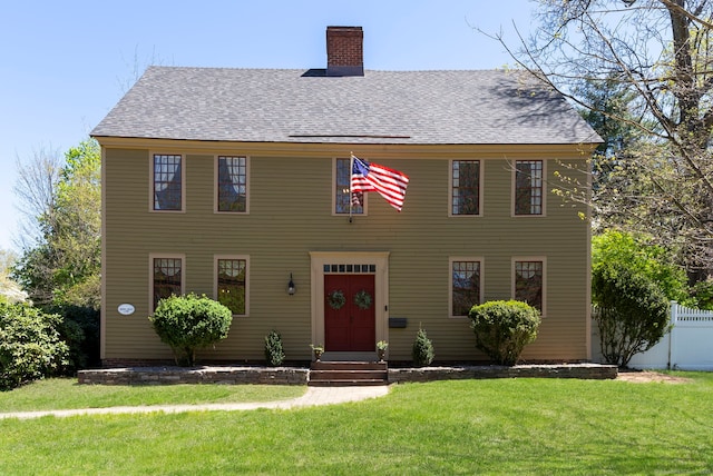 1696 Main St, Glastonbury, CT 06033 - colonial-style house with a front lawn, fence, roof with shingles, and a chimney