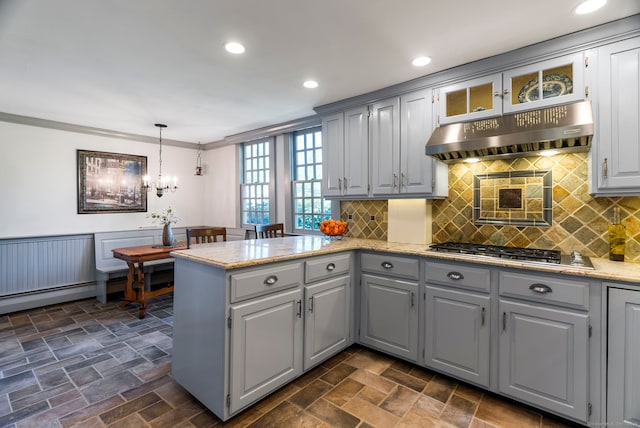 1696 Main St, Glastonbury, CT 06033 - kitchen with a peninsula, gray cabinetry, under cabinet range hood, and stainless steel gas cooktop