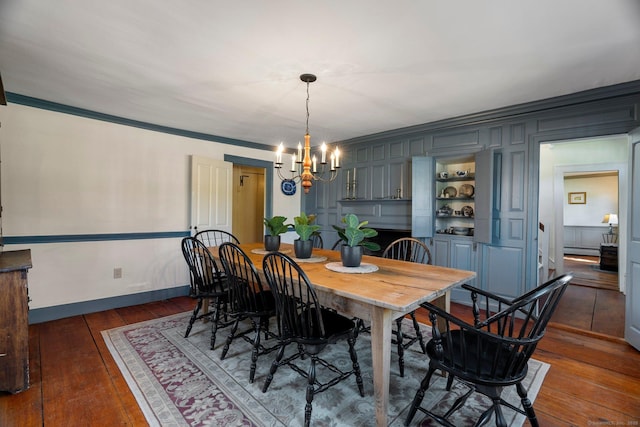 1696 Main St, Glastonbury, CT 06033 - dining space with dark wood finished floors, baseboards, baseboard heating, a chandelier, and ornamental molding