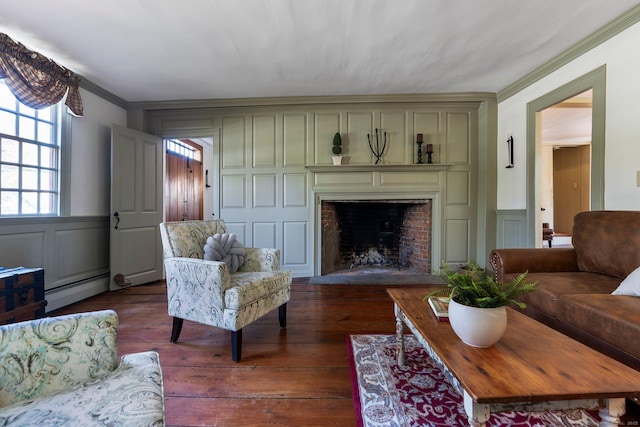 1696 Main St, Glastonbury, CT 06033 - living area with a decorative wall, a baseboard heating unit, ornamental molding, and a fireplace with flush hearth
