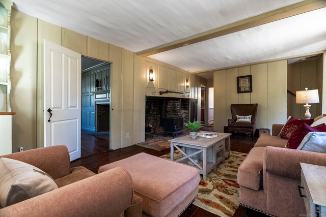 1696 Main St, Glastonbury, CT 06033 - living area with a wood stove, a decorative wall, and wood finished floors