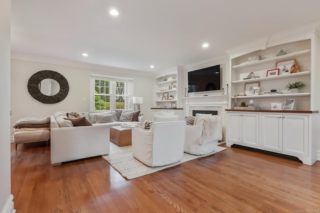 123 Richmond Hill Rd Unit 20, New Canaan, CT 06840 - living area with crown molding, a fireplace, wood finished floors, recessed lighting, and built in shelves