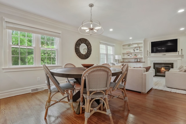 123 Richmond Hill Rd Unit 20, New Canaan, CT 06840 - dining area with ornamental molding, a glass covered fireplace, a chandelier, light wood-type flooring, and recessed lighting