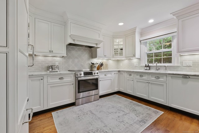 123 Richmond Hill Rd Unit 20, New Canaan, CT 06840 - kitchen with stainless steel electric range oven, white cabinets, and backsplash
