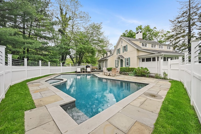 view of pool with a patio area, a fenced backyard, and an in-ground hot tub