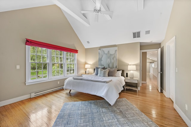 bedroom with a baseboard radiator, high vaulted ceiling, light wood finished floors, baseboards, and ceiling fan