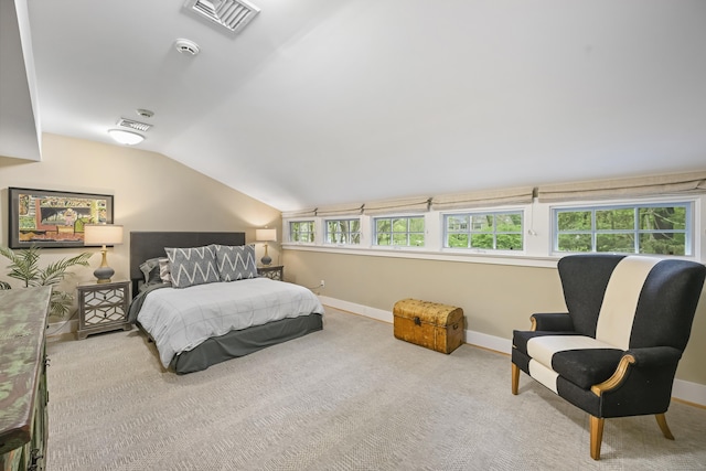 carpeted bedroom with baseboards and vaulted ceiling