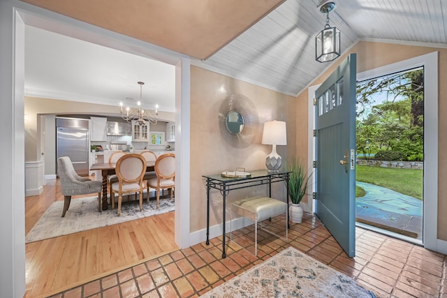 entryway featuring a chandelier, wood finished floors, and crown molding