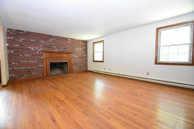 299 Valley Rd, North Branford, CT 06471 - unfurnished living room with light wood-style floors, a fireplace, and a baseboard heating unit