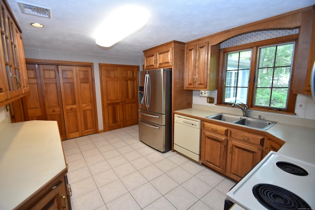 299 Valley Rd, North Branford, CT 06471 - kitchen featuring white appliances, a sink, wallpapered walls, brown cabinetry, and light countertops