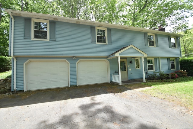 299 Valley Rd, North Branford, CT 06471 - colonial house featuring asphalt driveway, a chimney, and a garage