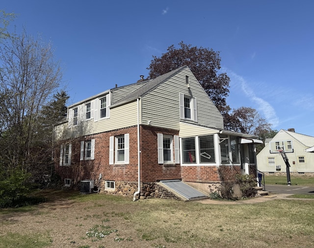 30 May St, Meriden, CT 06451 - rear view of house featuring central AC, a lawn, and brick siding