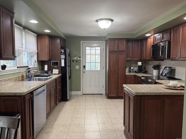 30 May St, Meriden, CT 06451 - kitchen with appliances with stainless steel finishes, a sink, light countertops, light tile patterned floors, and baseboards
