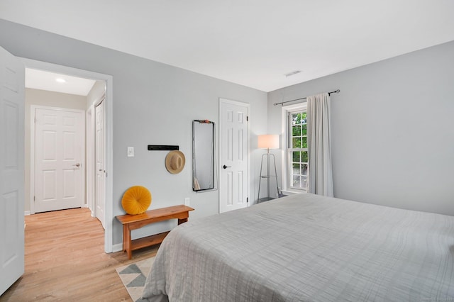 bedroom featuring light wood-type flooring and baseboards